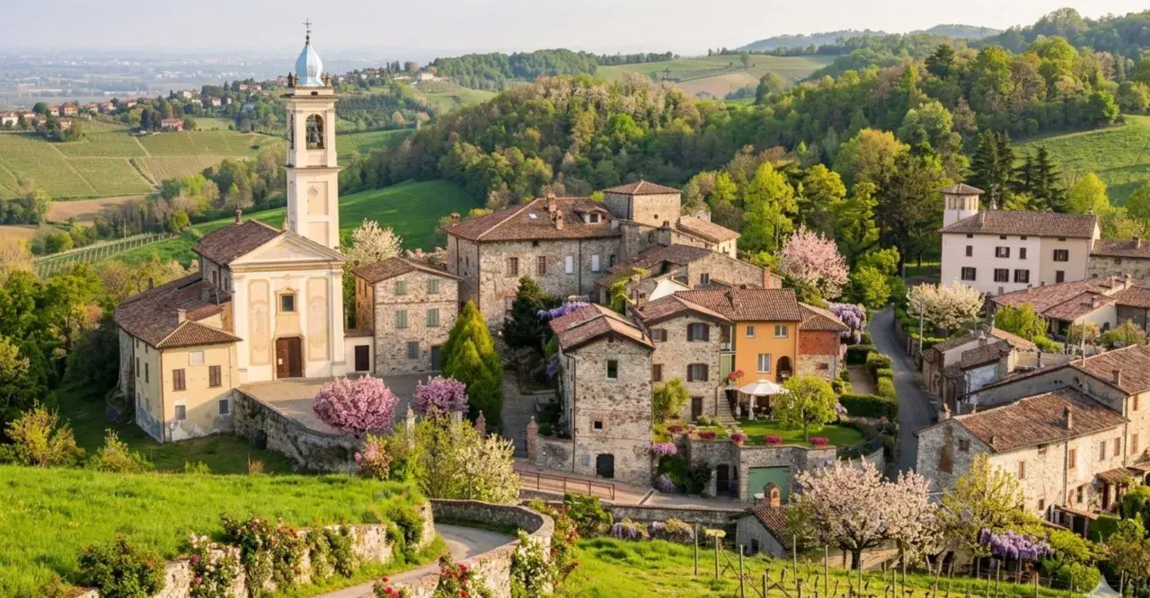 Borgo pittoresco con chiesa e campanile, colline verdi e fiori in primavera. Un luogo incantevole per scoprire cosa vedere a Golferenzo.