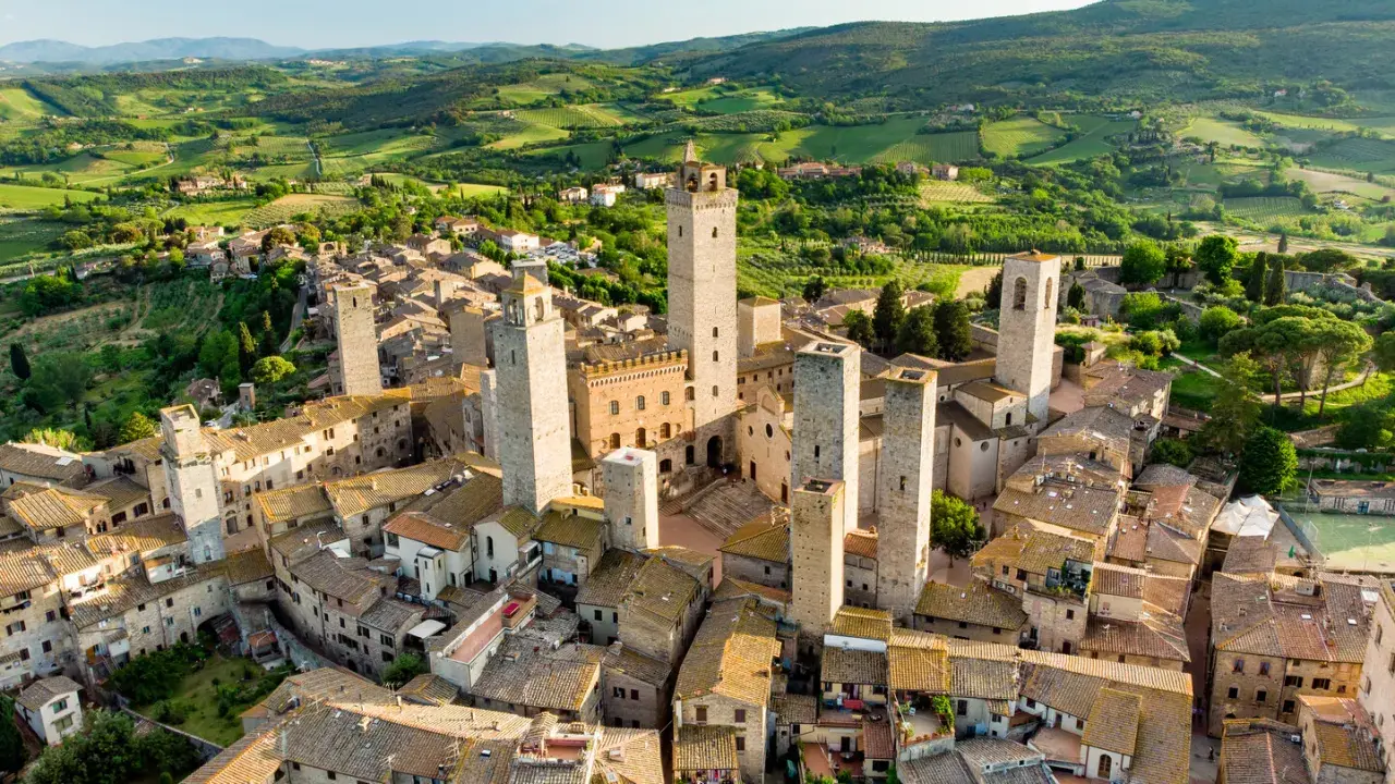 Aerial view of San Gimignano, Italy, with its medieval towers and Tuscan countryside.
