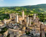 Aerial view of San Gimignano, Italy, with its medieval towers and Tuscan countryside.