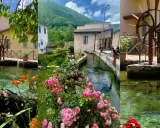 Borghi vicino Foligno: un ruscello attraversa un villaggio con mulini ad acqua, case antiche e fiori colorati.