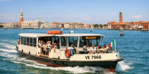Barca con passeggeri diretta a Murano, con Venezia sullo sfondo. Un modo semplice per capire come arrivare a Murano da Venezia.