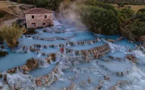 Cascate naturali con acqua azzurra e vapore, un luogo idilliaco per godersi le terme di Saturnia gratis.