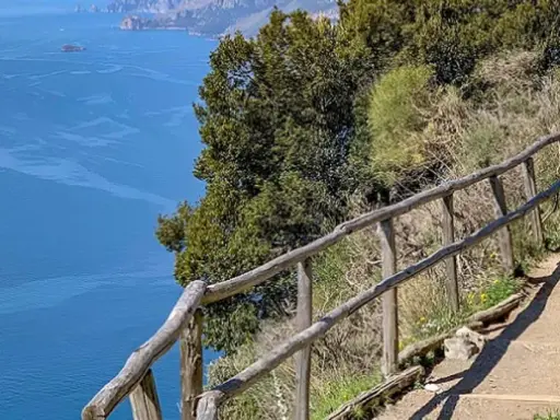 Escursionista sul sentiero degli dei ad Agerola, con vista mozzafiato sul mare blu e le isole.