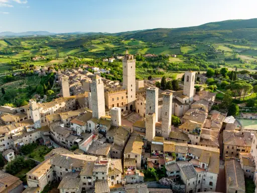 Aerial view of San Gimignano, Italy, with its medieval towers and Tuscan countryside.