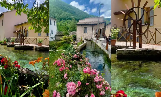 Borghi vicino Foligno: un ruscello attraversa un villaggio con mulini ad acqua, case antiche e fiori colorati.