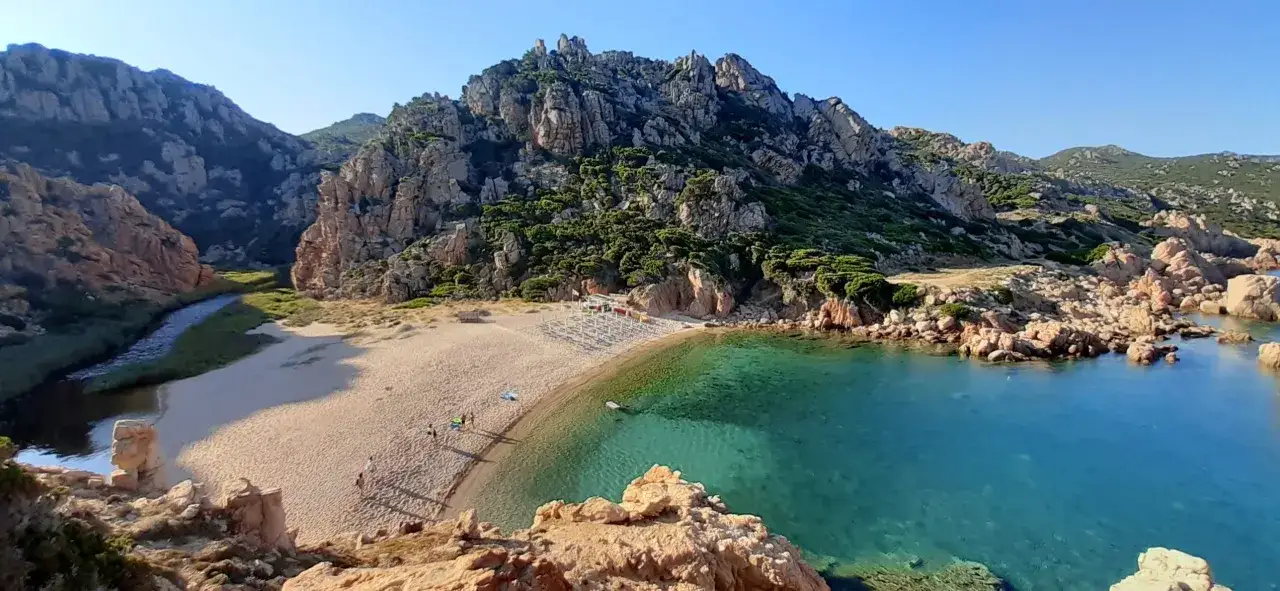 Baia con sabbia dorata, acqua cristallina e rocce scolpite dal vento. Un vero gioiello tra le spiagge più belle della Sardegna.