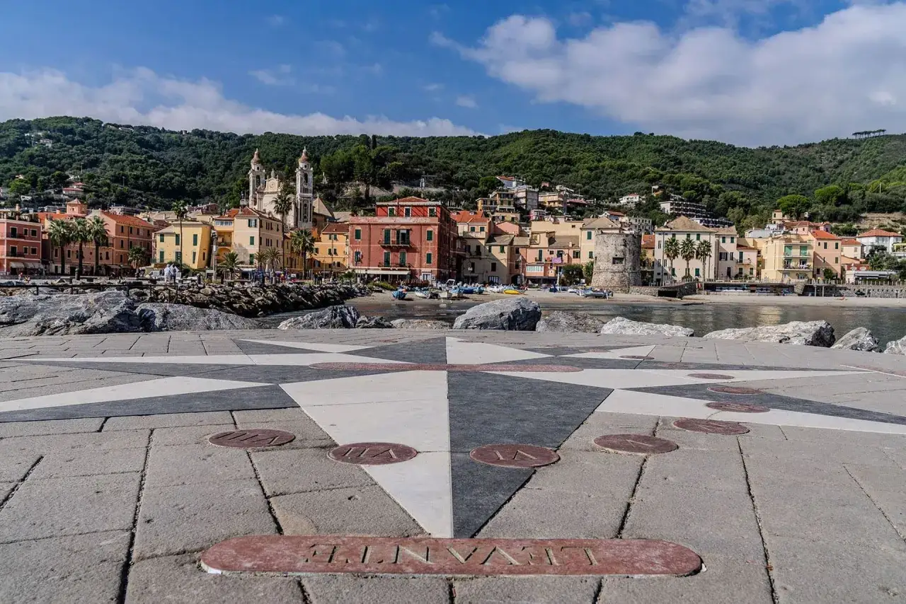 Laigueglia centro storico: un mare di colori e storia, con la rosa dei venti che guida verso il borgo ligure.